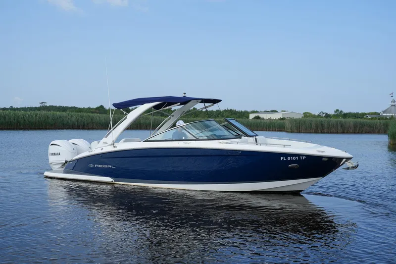  Yacht Photos Pics 2023 Regal 29 OBX boat on calm water, featuring sleek design and Yamaha engines.