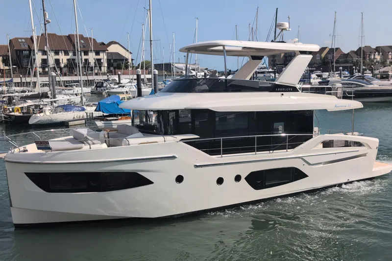 In Stock Yacht Photos Pics 2025 Absolute Navetta 53 yacht docked in a marina, showcasing sleek design and modern features.