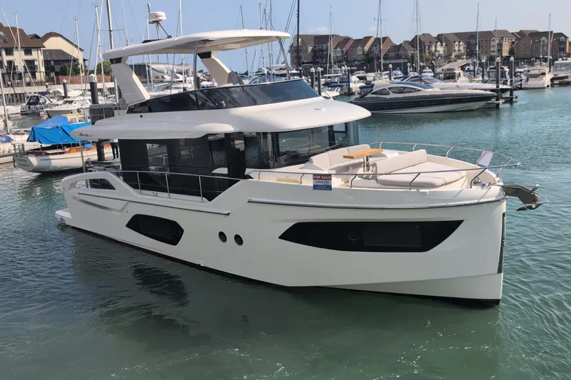 In Stock Yacht Photos Pics 2025 Absolute Navetta 53 yacht docked in a marina, showcasing sleek design and luxury features.