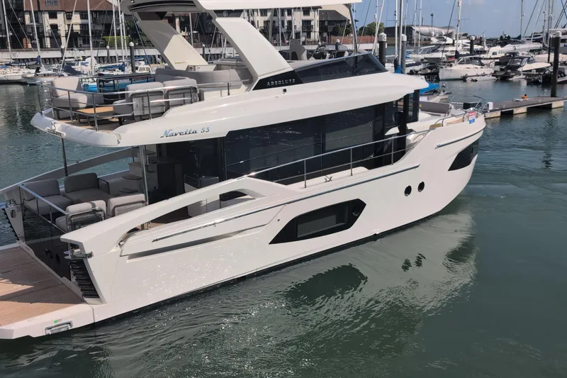 In Stock Yacht Photos Pics 2025 Absolute Navetta 53 luxury yacht docked in marina, showcasing sleek design and spacious deck.