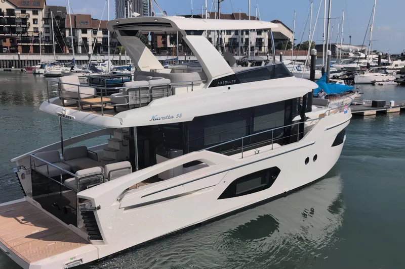 In Stock Yacht Photos Pics 2025 Absolute Navetta 53 yacht docked in a marina, showcasing sleek design and luxury features.