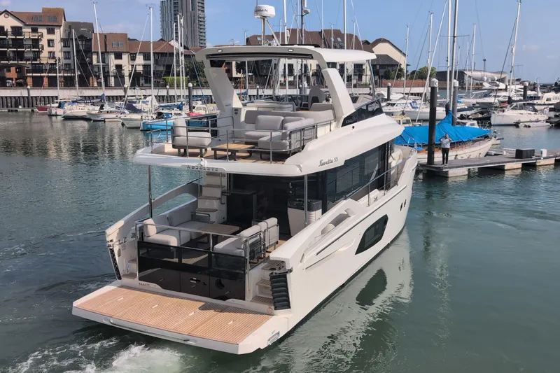 In Stock Yacht Photos Pics Luxury Absolute Navetta 53 yacht, 2025 model, docked in a marina with surrounding boats.