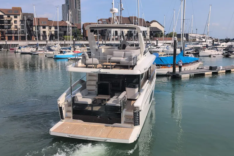 In Stock Yacht Photos Pics Luxury Absolute Navetta 53 yacht, 2025 model, docked in a marina with surrounding boats.