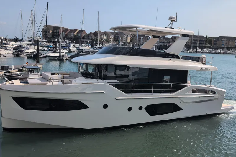 In Stock Yacht Photos Pics 2025 Absolute Navetta 53 yacht docked in a marina, showcasing sleek design and luxury features.