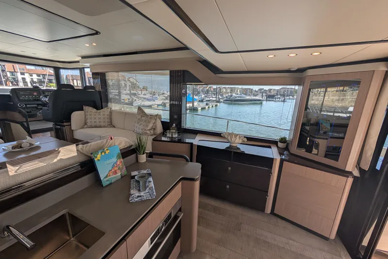 In Stock Yacht Photos Pics Luxurious interior of 2025 Absolute Navetta 53 yacht with marina view.