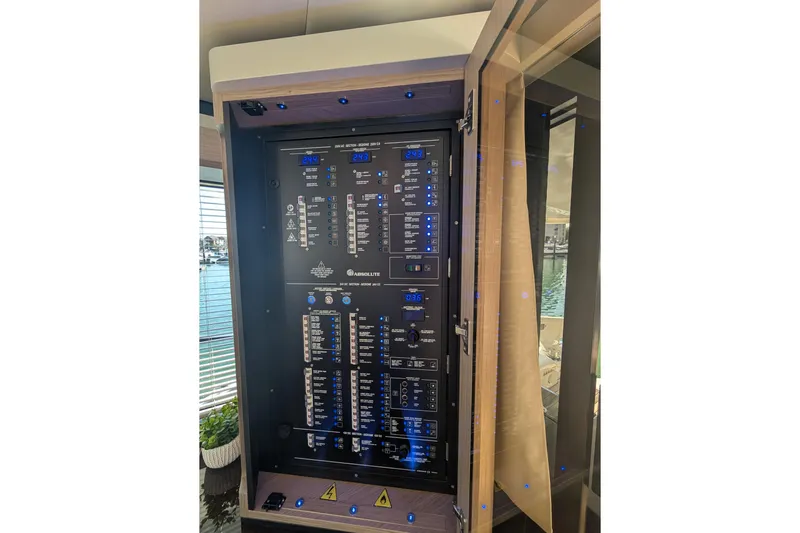 In Stock Yacht Photos Pics Electrical control panel on the 2025 Absolute Navetta 53 yacht, featuring digital displays and switches.