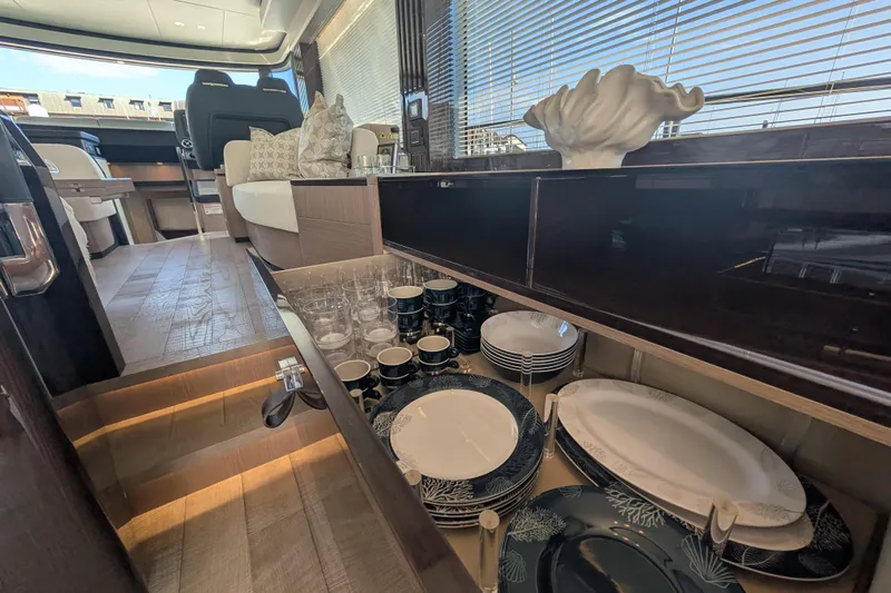 In Stock Yacht Photos Pics Luxurious interior of 2025 Absolute Navetta 53 yacht with elegant dining set and modern decor.