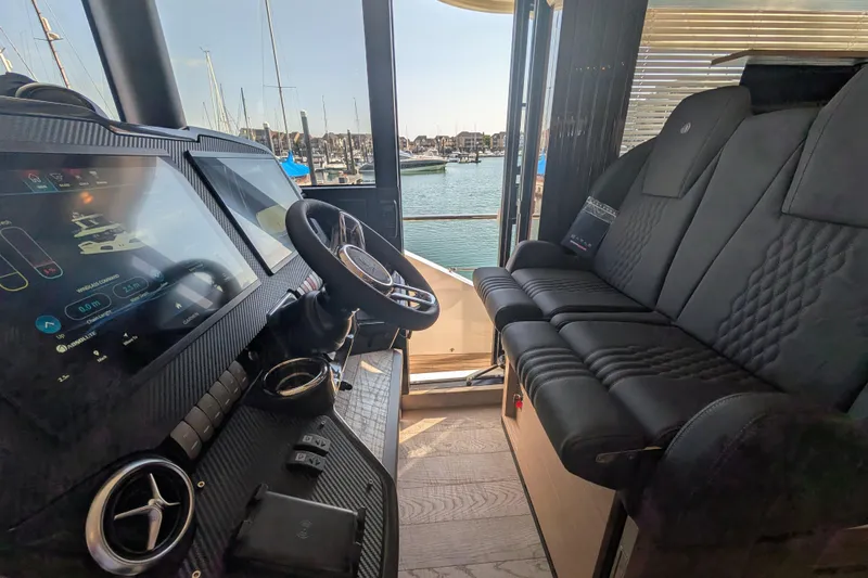 In Stock Yacht Photos Pics Interior of 2025 Absolute Navetta 53 yacht with modern helm and seating.