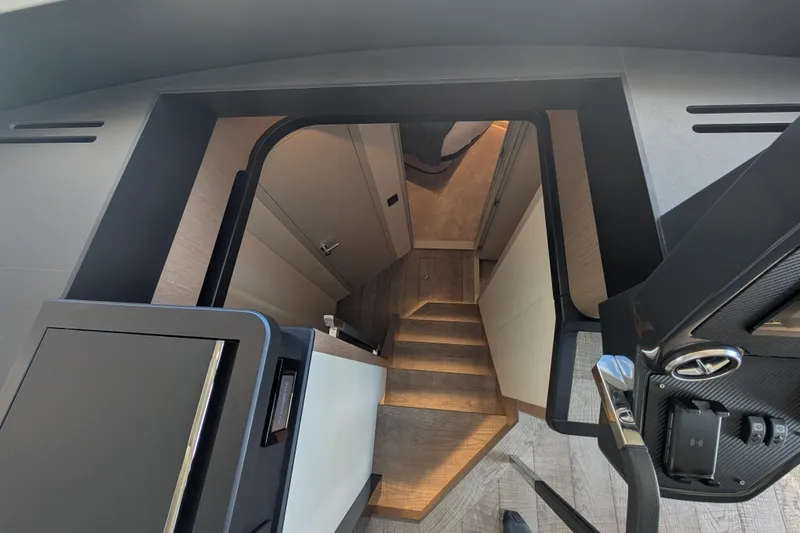 In Stock Yacht Photos Pics Interior staircase of 2025 Absolute Navetta 53 yacht, featuring modern design and wood finish.