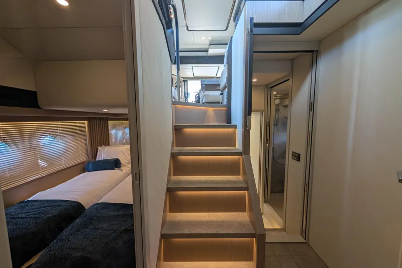 In Stock Yacht Photos Pics Interior of 2025 Absolute Navetta 53 yacht with modern staircase and cozy bedroom.