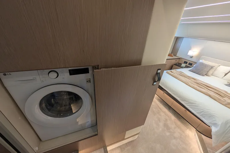 In Stock Yacht Photos Pics Luxurious bedroom with integrated washer in 2025 Absolute Navetta 53 yacht.