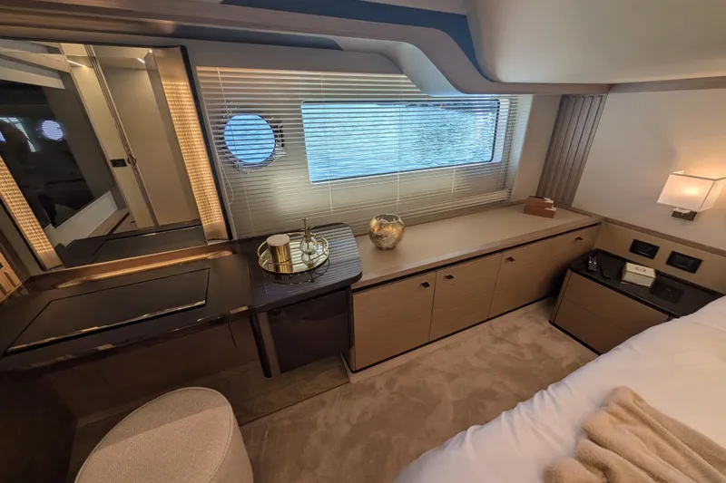 In Stock Yacht Photos Pics Luxurious interior of 2025 Absolute Navetta 53 yacht with elegant furnishings and window view.