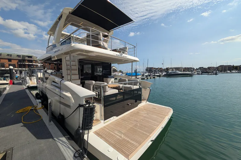 In Stock Yacht Photos Pics Luxury Absolute Navetta 53 yacht docked at marina, 2025 model, sunny day.