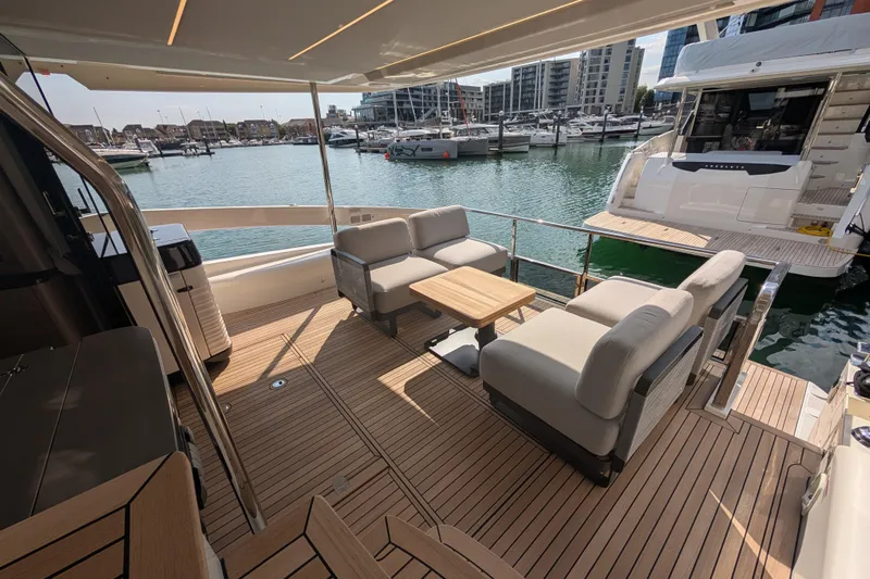 In Stock Yacht Photos Pics Luxurious 2025 Absolute Navetta 53 yacht deck with elegant seating and marina view.