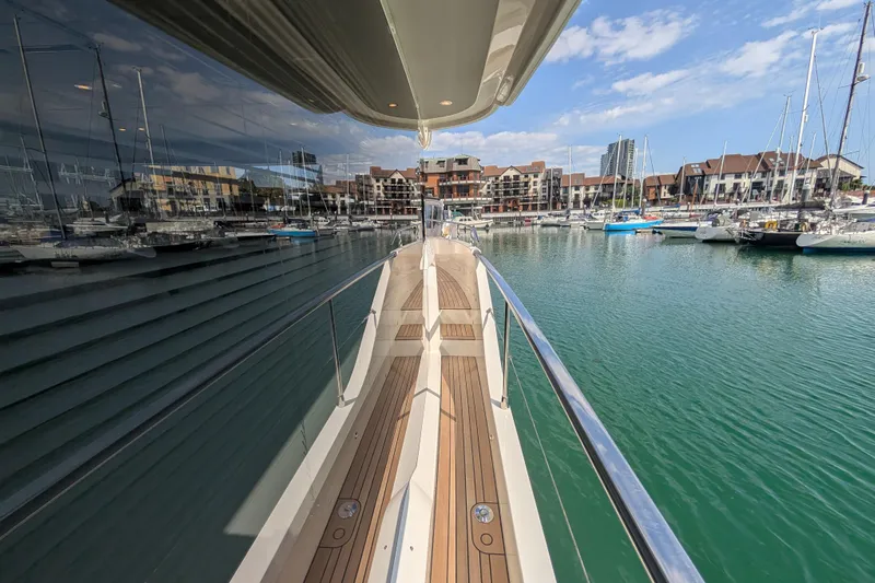 In Stock Yacht Photos Pics 2025 Absolute Navetta 53 yacht docked in a marina with clear skies.