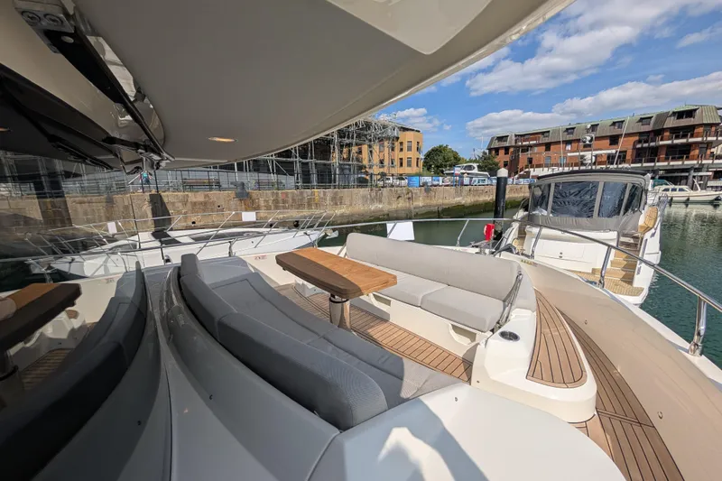 In Stock Yacht Photos Pics Luxurious 2025 Absolute Navetta 53 yacht with elegant outdoor seating and wooden deck.