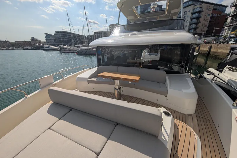 In Stock Yacht Photos Pics Luxurious 2025 Absolute Navetta 53 yacht with spacious deck and modern seating in marina.