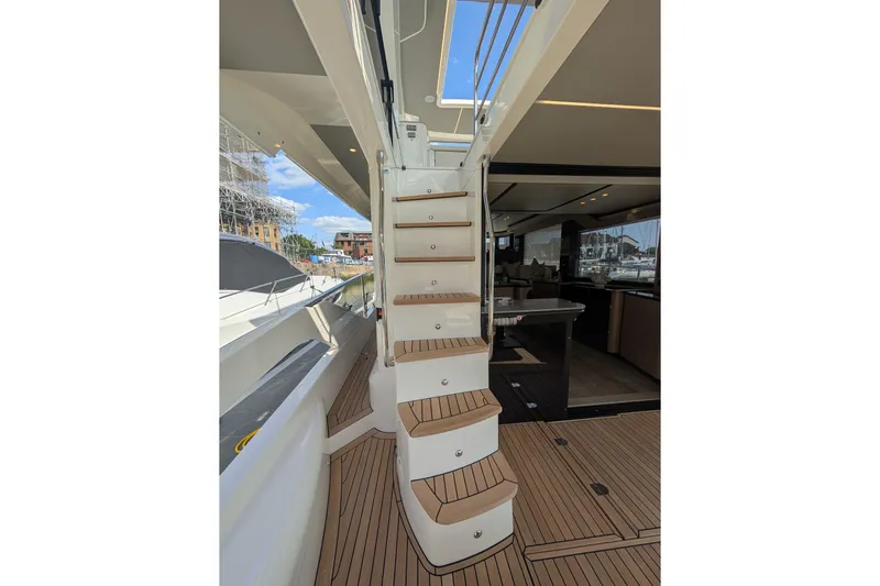 In Stock Yacht Photos Pics Staircase on 2025 Absolute Navetta 53 yacht, featuring elegant teak decking and modern design.