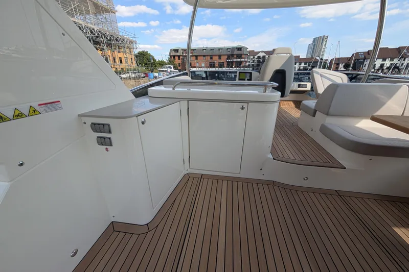 In Stock Yacht Photos Pics Luxurious deck of 2025 Absolute Navetta 53 yacht with sleek seating and cabinetry.