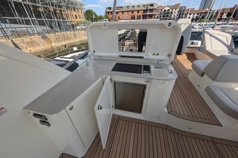 In Stock Yacht Photos Pics Outdoor kitchen on 2025 Absolute Navetta 53 yacht with sink and grill.