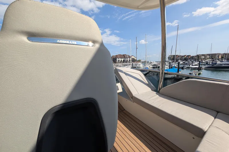 In Stock Yacht Photos Pics Luxurious Absolute Navetta 53 yacht interior, 2025 model, docked at a marina under clear skies.