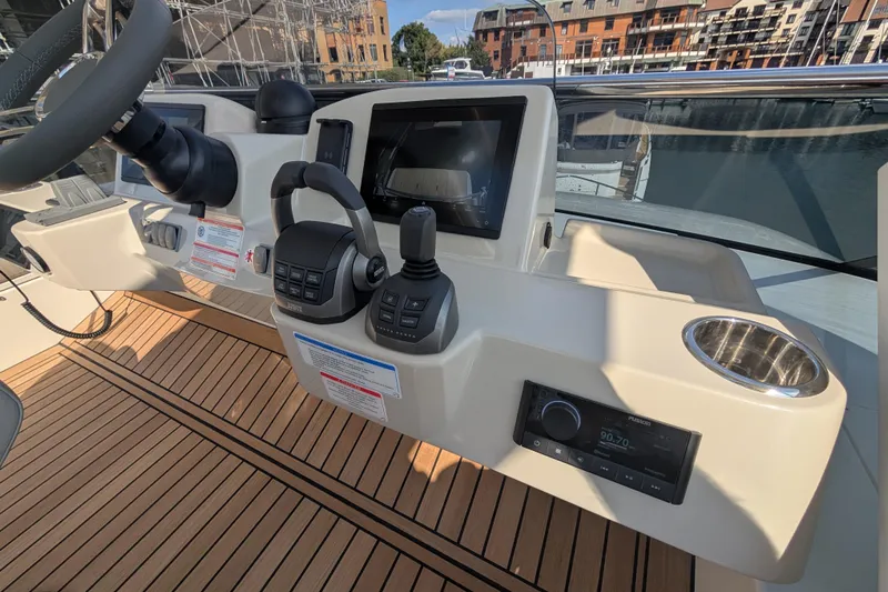 In Stock Yacht Photos Pics Helm of 2025 Absolute Navetta 53 yacht with modern controls and navigation display.