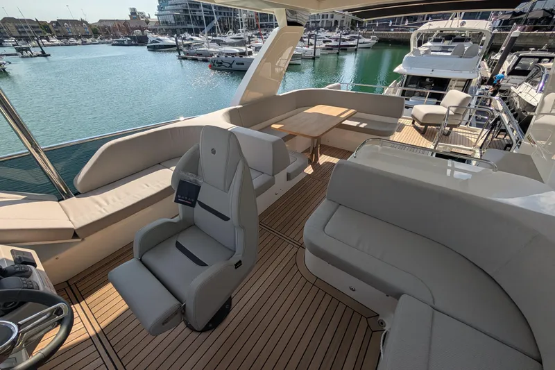 In Stock Yacht Photos Pics Luxurious 2025 Absolute Navetta 53 yacht interior with elegant seating and scenic marina view.