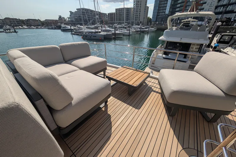 In Stock Yacht Photos Pics Luxurious seating on the 2025 Absolute Navetta 53 yacht, docked in a marina.