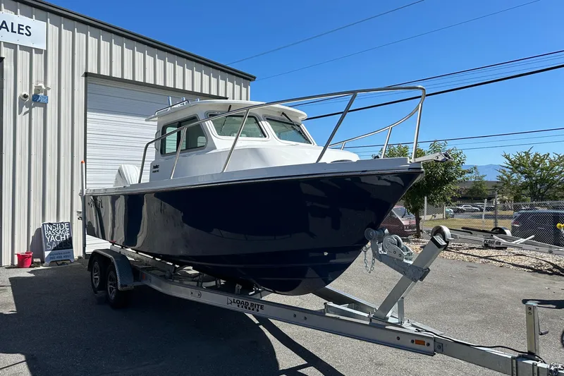  Yacht Photos Pics 2026 Parker 2220 boat on trailer outside yacht sales building.