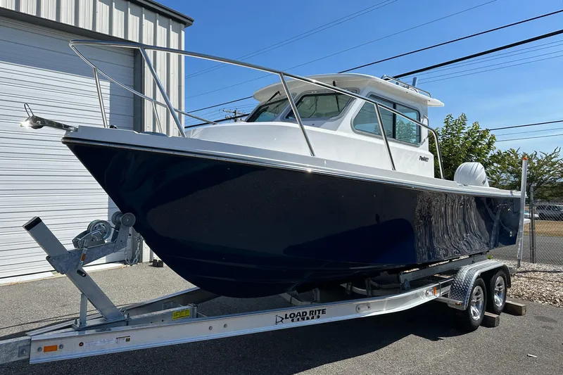  Yacht Photos Pics Parker 2220 boat on trailer, 2026 model, parked outside a building.