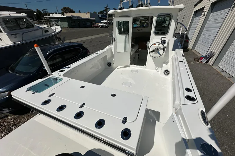  Yacht Photos Pics 2026 Parker 2220 boat with spacious deck and modern cockpit, parked outdoors.