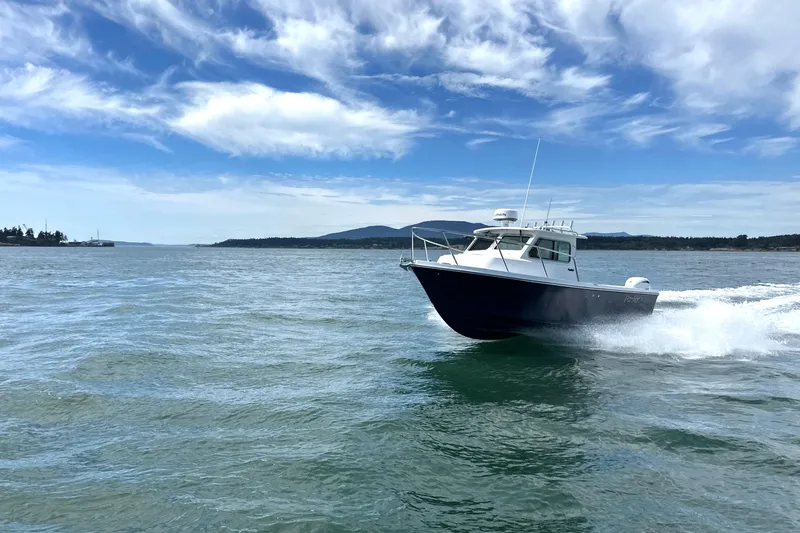  Yacht Photos Pics 2026 Parker 227 Explorer boat cruising on open water under a clear blue sky.