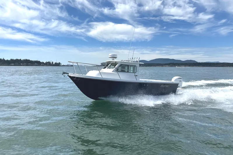  Yacht Photos Pics 2026 Parker 227 Explorer boat cruising on open water under a clear blue sky.