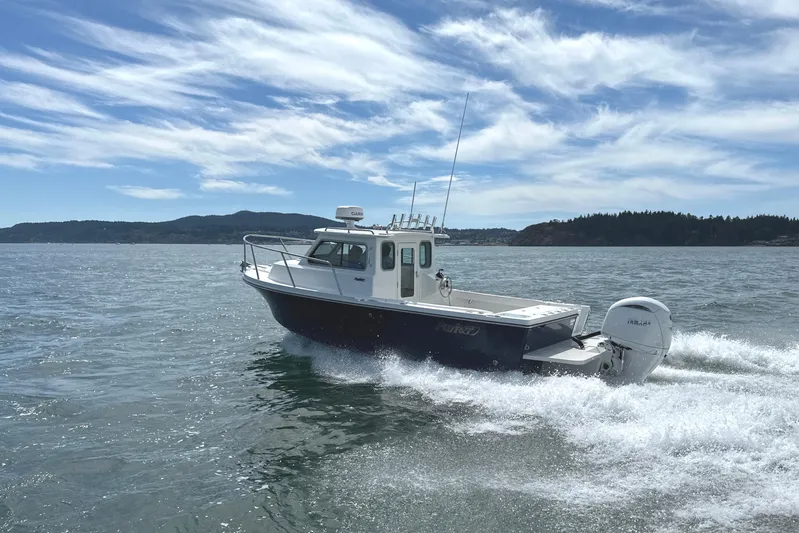  Yacht Photos Pics 2026 Parker 227 Explorer boat cruising on open water under a clear sky.