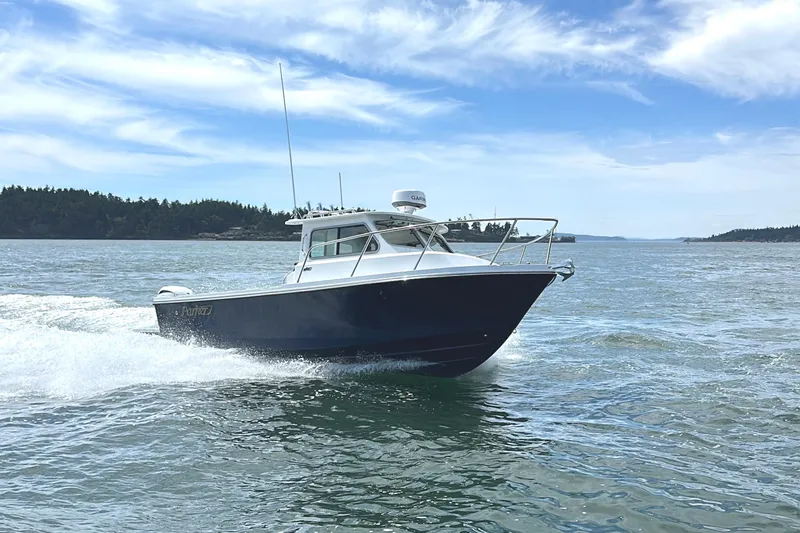  Yacht Photos Pics 2026 Parker 227 Explorer boat cruising on open water under a clear blue sky.