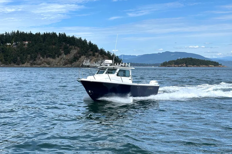  Yacht Photos Pics 2026 Parker 227 Explorer boat cruising on scenic coastal waters.