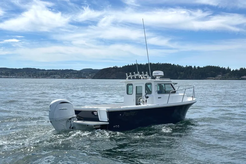  Yacht Photos Pics 2026 Parker 227 Explorer boat cruising on a scenic lake under a blue sky.