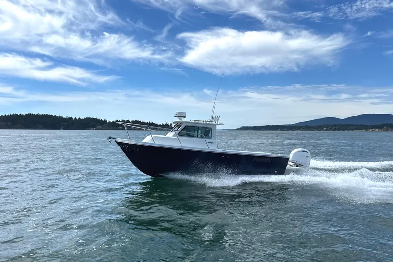  Yacht Photos Pics 2026 Parker 227 Explorer boat cruising on open water under a clear blue sky.
