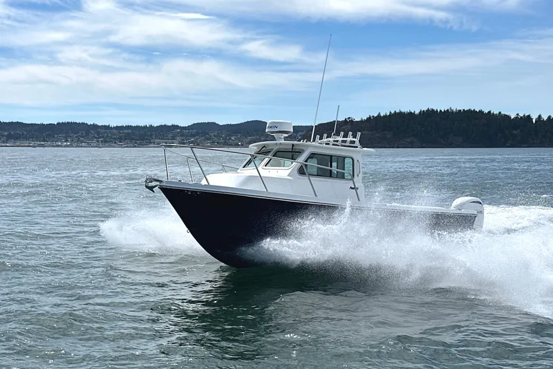  Yacht Photos Pics 2026 Parker 227 Explorer boat cruising on open water with scenic background.