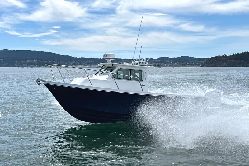  Yacht Photos Pics 2026 Parker 227 Explorer boat cruising on open water with scenic background.