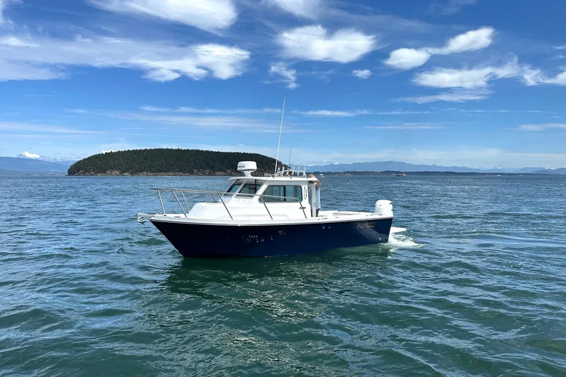  Yacht Photos Pics 2026 Parker 227 Explorer boat cruising on open water under a clear blue sky.