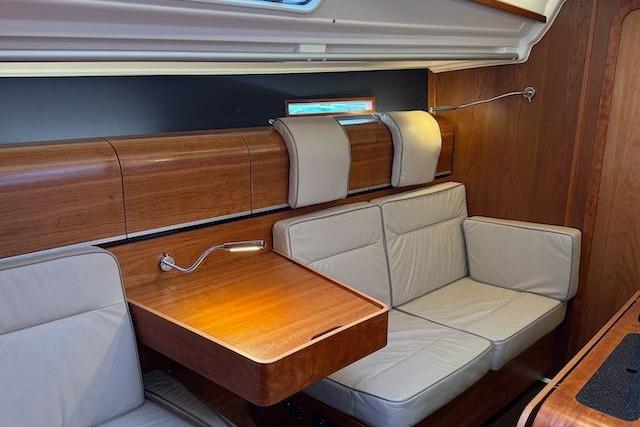 2017 Dehler 38 yacht interior with wooden finish and beige seating area.