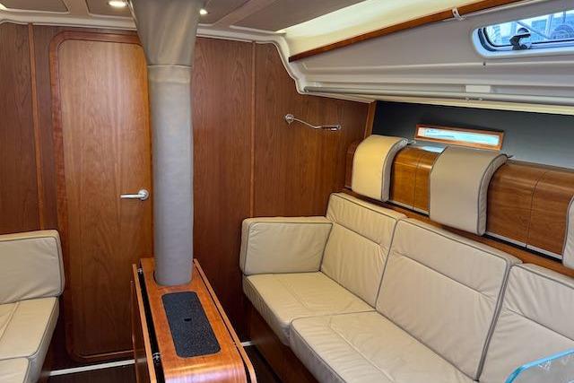 Interior of 2017 Dehler 38 yacht with beige seating and wooden accents.
