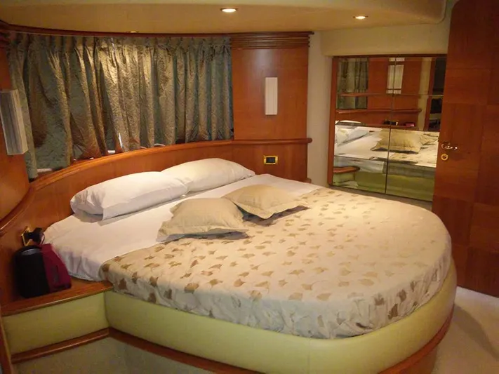  Yacht Photos Pics Luxurious bedroom interior of 2009 Azimut 62 Evolution yacht with elegant bedding and wood accents.