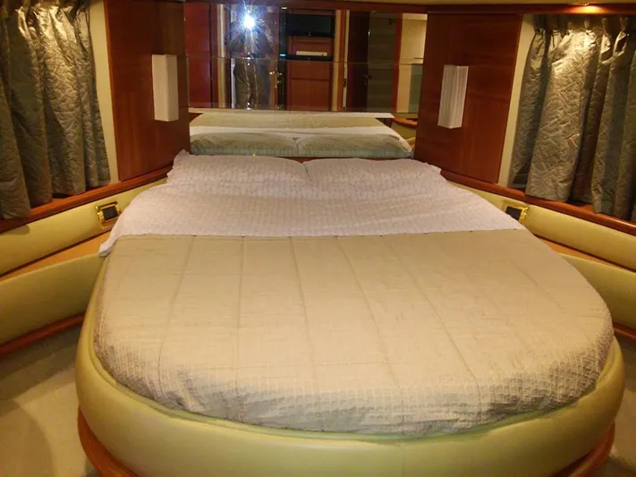  Yacht Photos Pics Luxurious bedroom interior of 2009 Azimut 62 Evolution yacht with elegant bedding and wood accents.