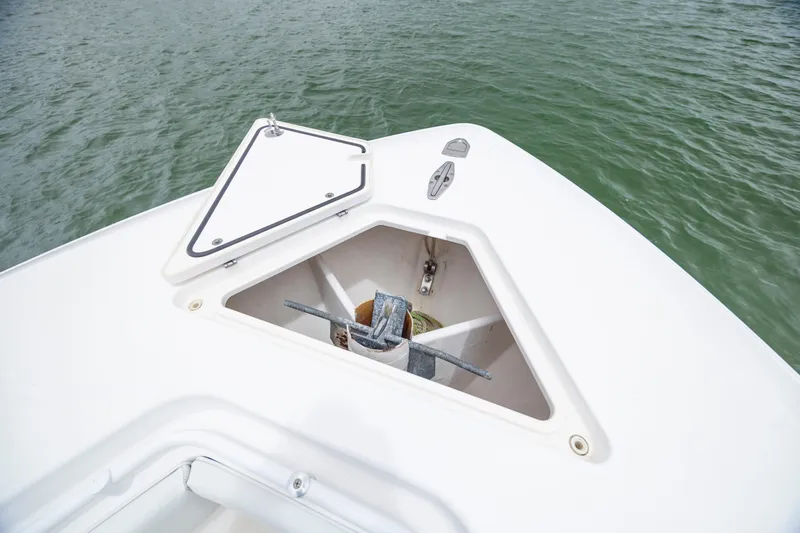  Yacht Photos Pics 2012 Contender 30 Tournament boat anchor compartment with open hatch on calm water.