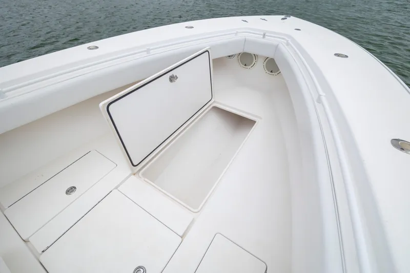  Yacht Photos Pics 2012 Contender 30 Tournament boat with open storage compartments on deck.