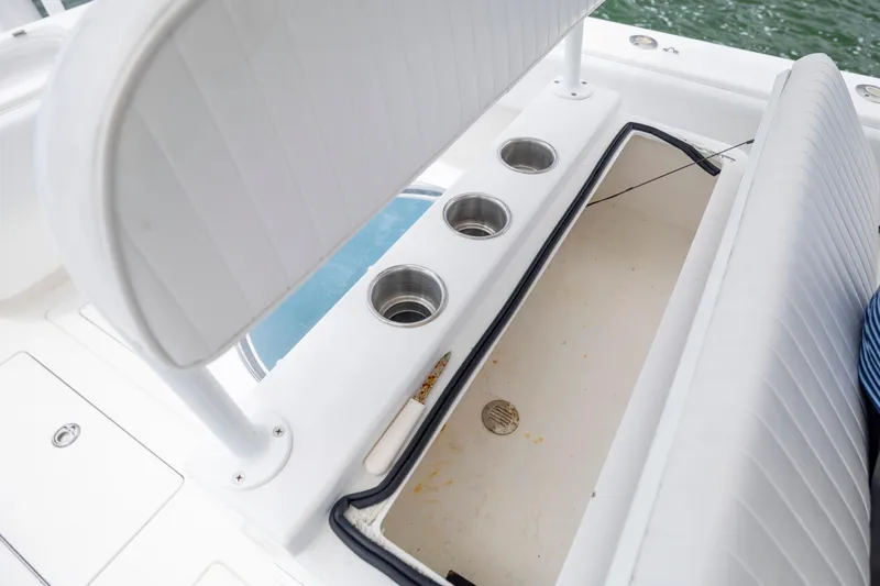  Yacht Photos Pics 2012 Contender 30 Tournament boat interior with storage compartment and cup holders.