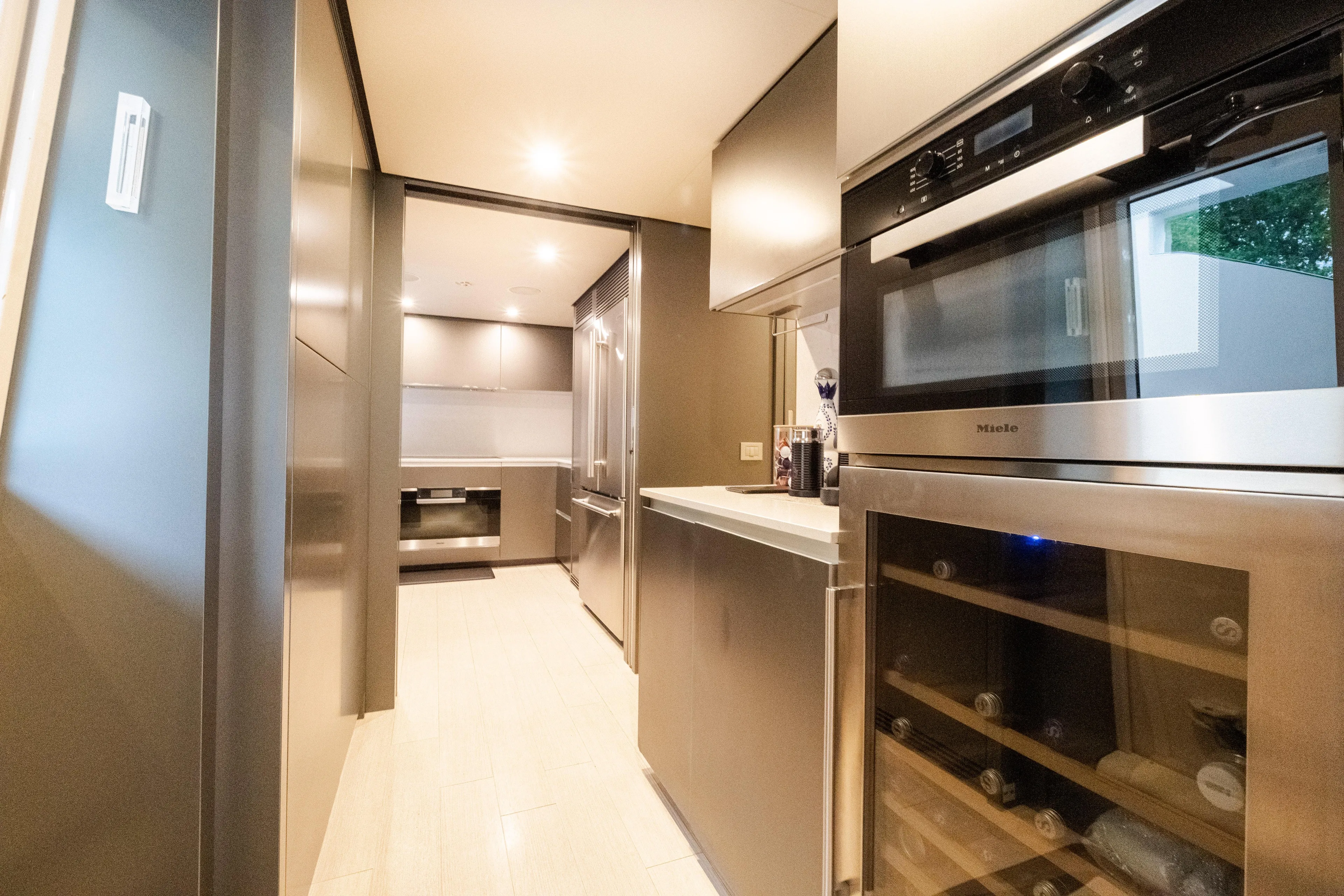 Amity Yacht Photos Pics Modern kitchen interior on 2018 Custom Line Navetta 33 yacht, featuring sleek appliances and cabinetry.