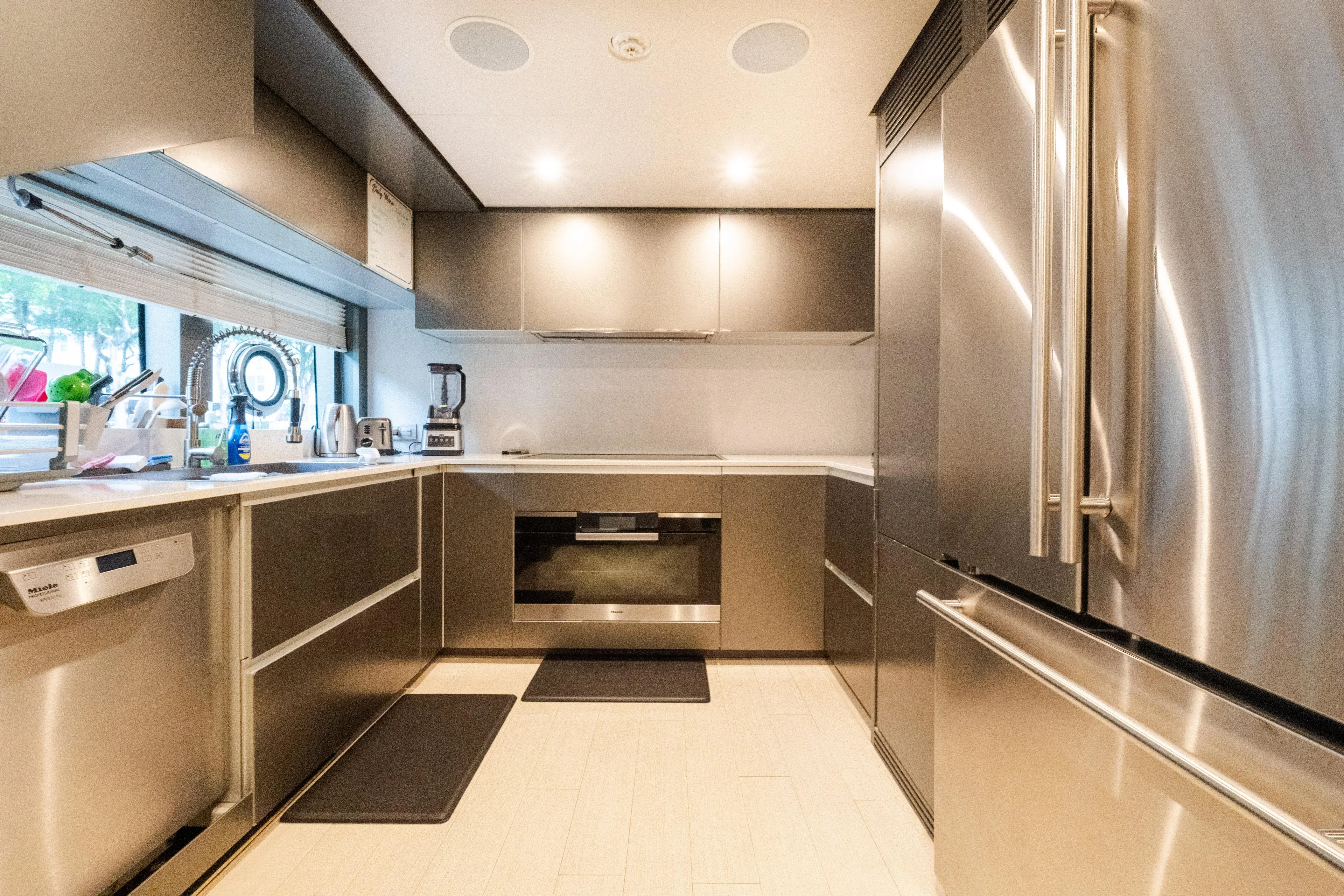 Amity Yacht Photos Pics Modern kitchen interior on 2018 Custom Line Navetta 33 yacht, featuring stainless steel appliances.